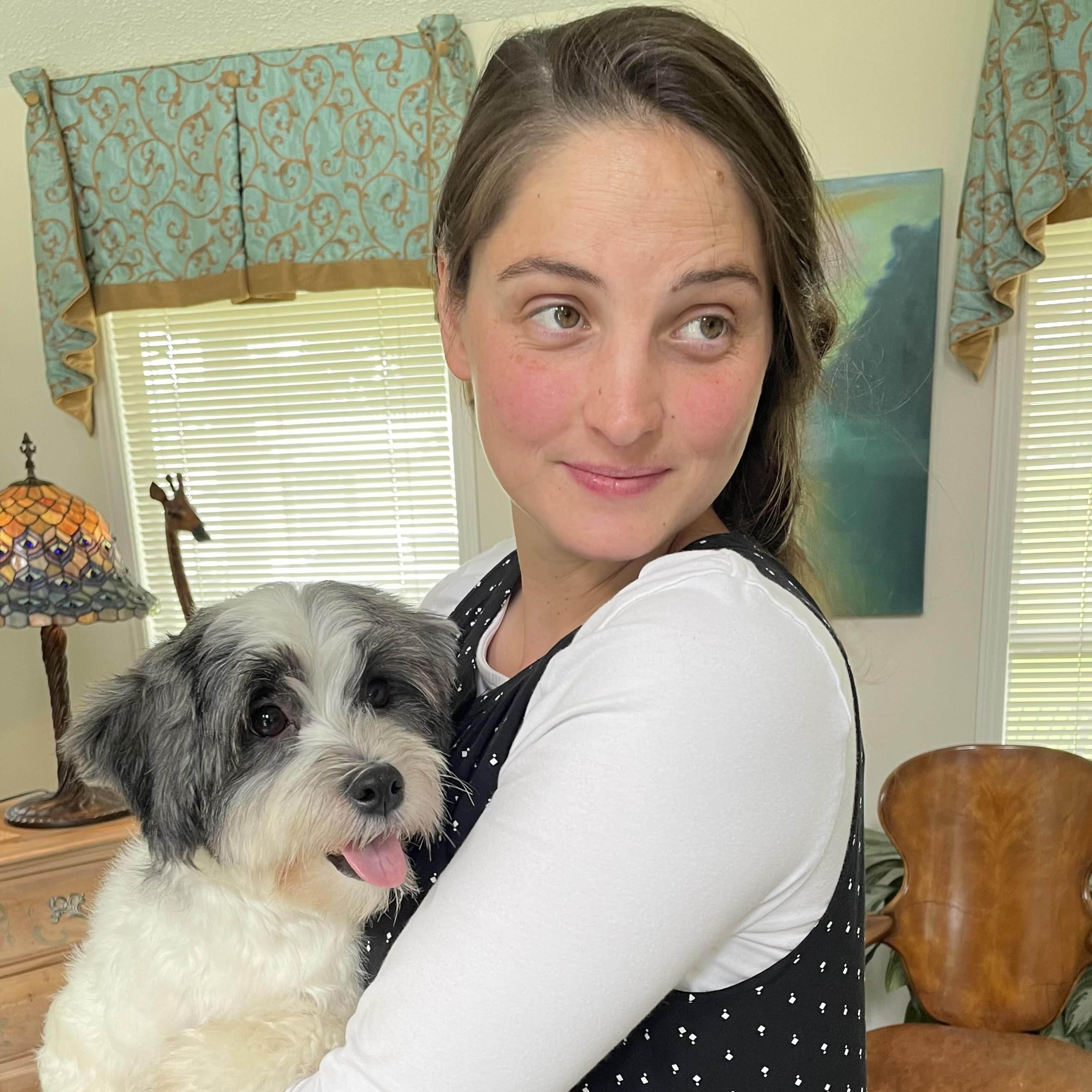 Kristy holding a black and white Havanese